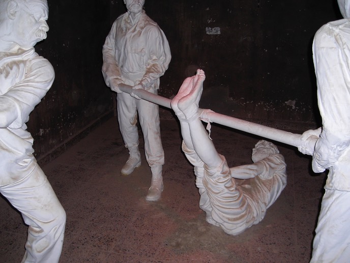 A very dark torture chamber with the aforementioned statues